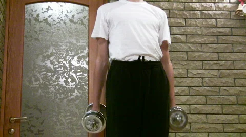 Teenager does exercise with dumbbells. Stock Footage 292913