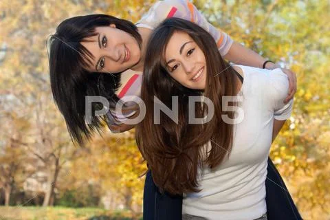 Teenager girls best friends have fun in the park Stock Photos