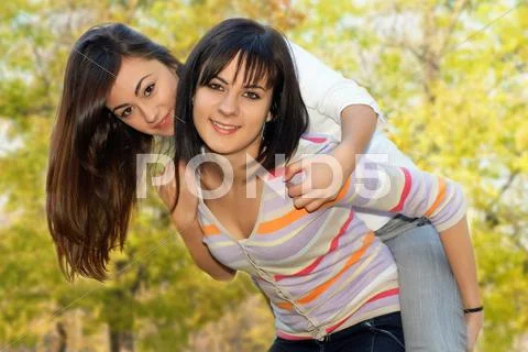 Teenager girls best friends have fun in the park Stock Photos