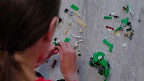 Teenager with hands constructs lego elements from back view Stock-Footage 157494117