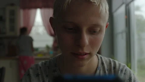 Teenager At Home At Table On Background Of Window Communicates By Video Chat Stock Footage 154647635