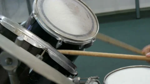 The teenager is learning to play drum set. Drum sticks knock on different drums Stock Footage 105471894