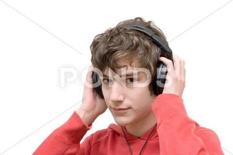 Teenager listening music with headphones Stock Photos