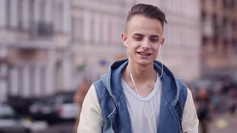 Teenager listening to music outdoors with his cellphone Stock Footage