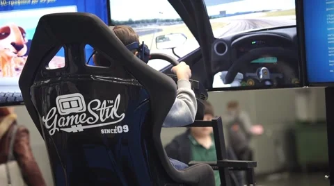 Teenager playing auto simulator with virtual reality VR glasses Stock Footage 68829992