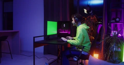 A teenager plays computer games while sitting in. Stock Footage 318996725