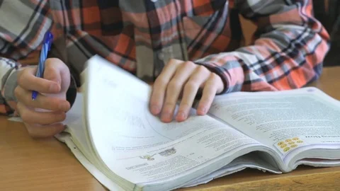 Teenager reads the tutorial on the lesson Stock Footage 71658874