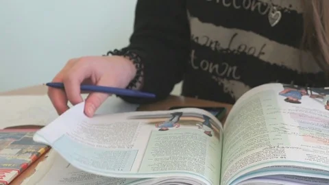 Teenager reads the tutorial on the lesson Stock Footage 71660706