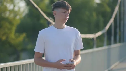 Teenager Reflecting in a Park While Using Smartphone in Solitude Stock Footage 315037127
