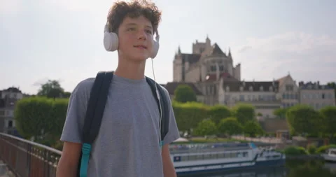 Teenager returns from school, walking through the streets of the city and Stock Footage 250086166