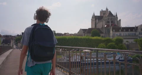 Teenager returns from school, walking through the streets of the city and Stock Footage 250086233