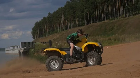 Teenager riding a quad bike Stock Footage 81680098
