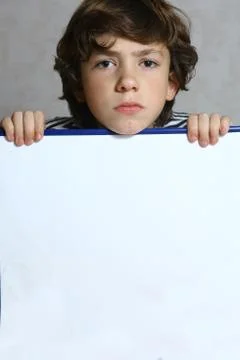 Teenager sad boy hold empty white sheet Stock Photos