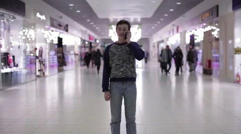 Teenager talking on the phone in a shopping center Stock Footage 59558416