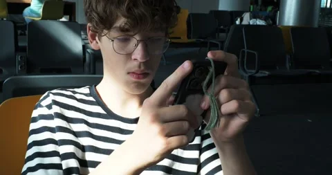Teenager using smartphone while waiting at airport Stock-Footage 319872870