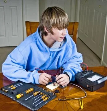 Teenager Using A Voltmeter Stock Photos