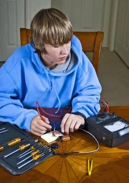 Teenager using a voltmeter Stock Photos