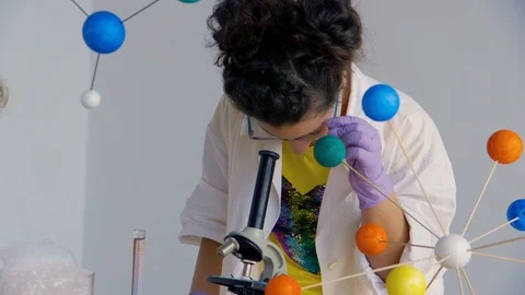 Teenagers looks in a microscope Stock Footage 90098065