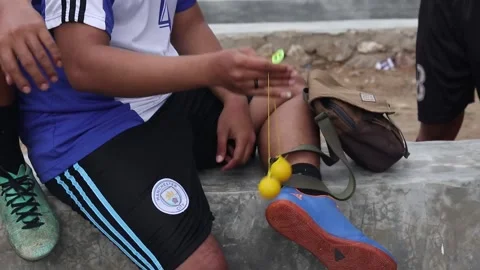 Teenagers playing Clacker Balls, also known as Latto-Latto in Indonesia Stock Footage 231539937