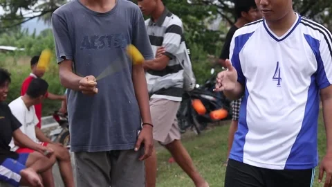 Teenagers playing Clacker Balls, also known as Latto-Latto in Indonesia Stock Footage 231540147