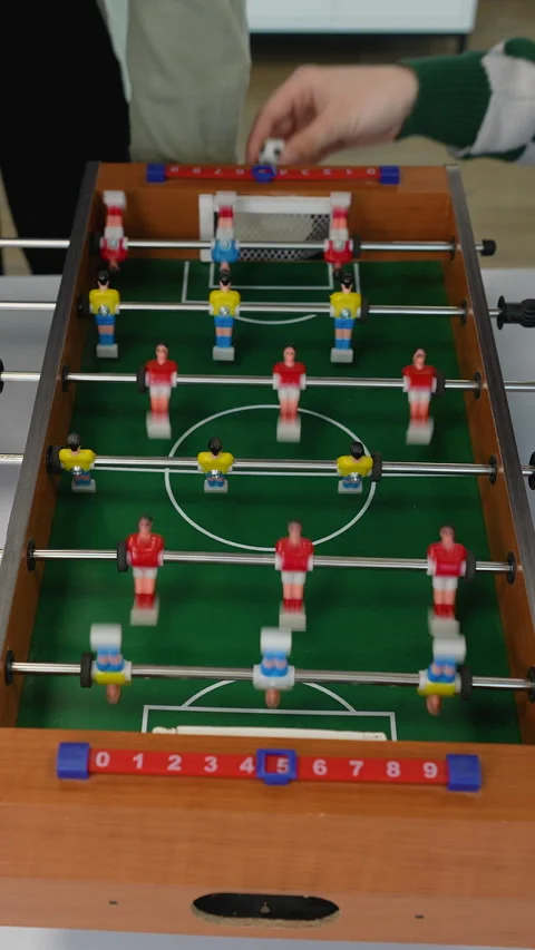 Teenagers playing foosball table soccer game Stock Footage 313245053