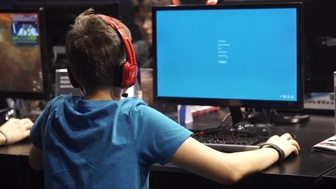 Teenagers playing video games on computers Stock Footage 69740396