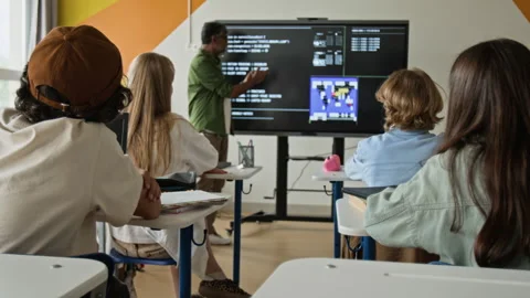 Teenagers Raising Hands in Coding Class with Multiethnic Teacher Stock Footage 342821799