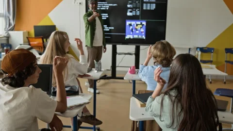 Teenagers Raising Hands in Coding Class with Indian Teacher Stock Footage 342823444