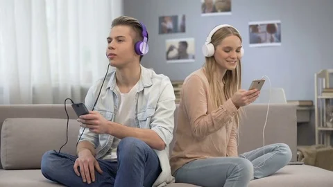 Teenagers synchronizing their playlists, sharing their interests to each other Stock-Footage 85209939