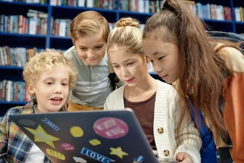 Teenagers using Computer and Looking at Screen in Library 스톡 사진