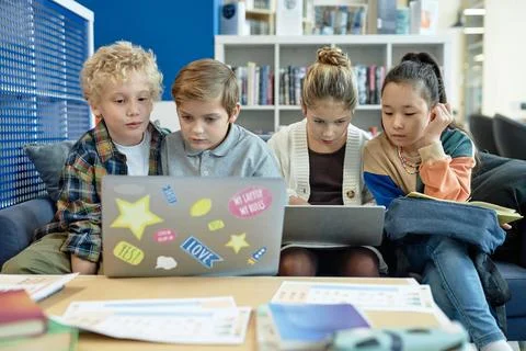 Teenagers using Computers in Break in Library Stock Photos