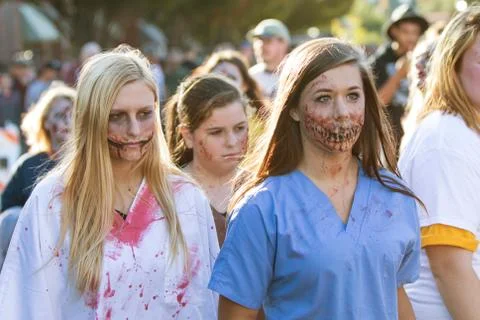 Teenagers Wearing Gruesome Zombie Makeup Walk At Georgia Halloween Festival Stock Photos