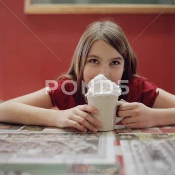 A teengirl with a mug of hot chocolate Stock Photos