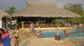 Teens and adults near the pool bar at Playa Blanca Resort, Panama 4k or 4k+ Resolution