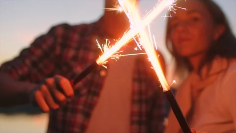 Teens are playing with sparkles at sunset Stock Footage 98946897
