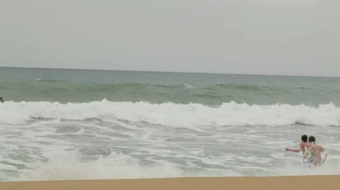 Teens enjoying the waves Stock Footage 11358145