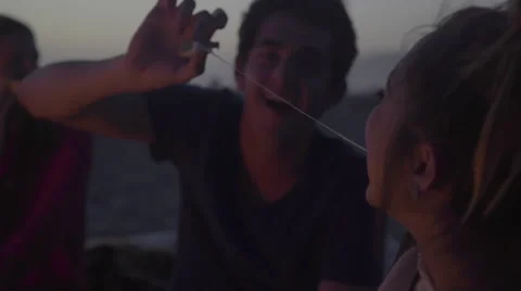 Teens feed marshmallows to each other Stock Footage 53495726