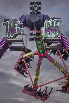 Teens get airborne while enjoying a carnival midway ride Stock Photos