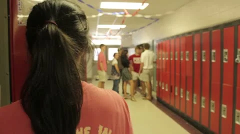 Teens goofing off in high school hallway over shoulder Stock Footage