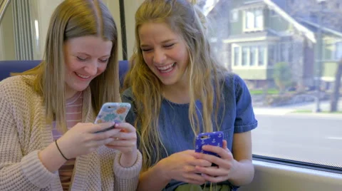 Teens Play On Their Smartphones, While Riding A Train, They Take Silly Selfies Video stock 61842323