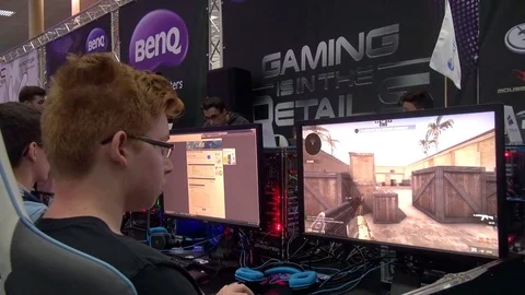 Teens playing shooters in a Comic-Con gaming hall Stock Footage 71965287