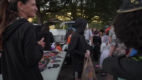 Teens Receiving Candy at Halloween Table Stock Footage 318115654