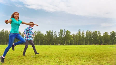 Teens running through the meadow Stock Footage 29551373