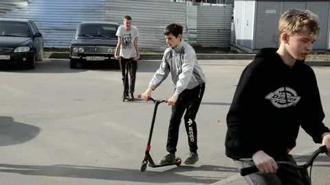 Teens on scooters Stock Footage 131282571