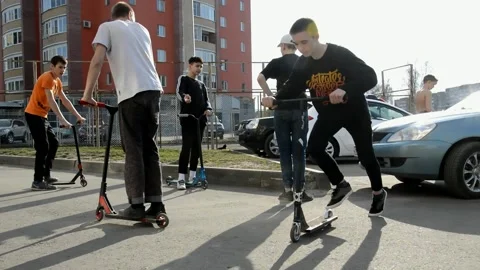 Teens on scooters Stock Footage 131346926