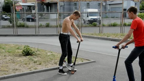 Teens on scooters Stock Footage 134467010