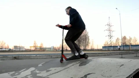 Teens on scooters performs a tricks Stock Footage 131197469