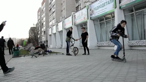 Teens on scooters performs a tricks Stock Footage 131347840