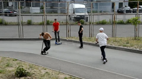 Teens on scooters performs a tricks Stock Footage 134469797