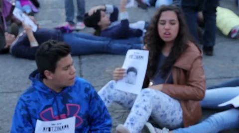 Teens shout slogans in a march protest for the students disappeared in Guerrero. Stock Footage 44215695
